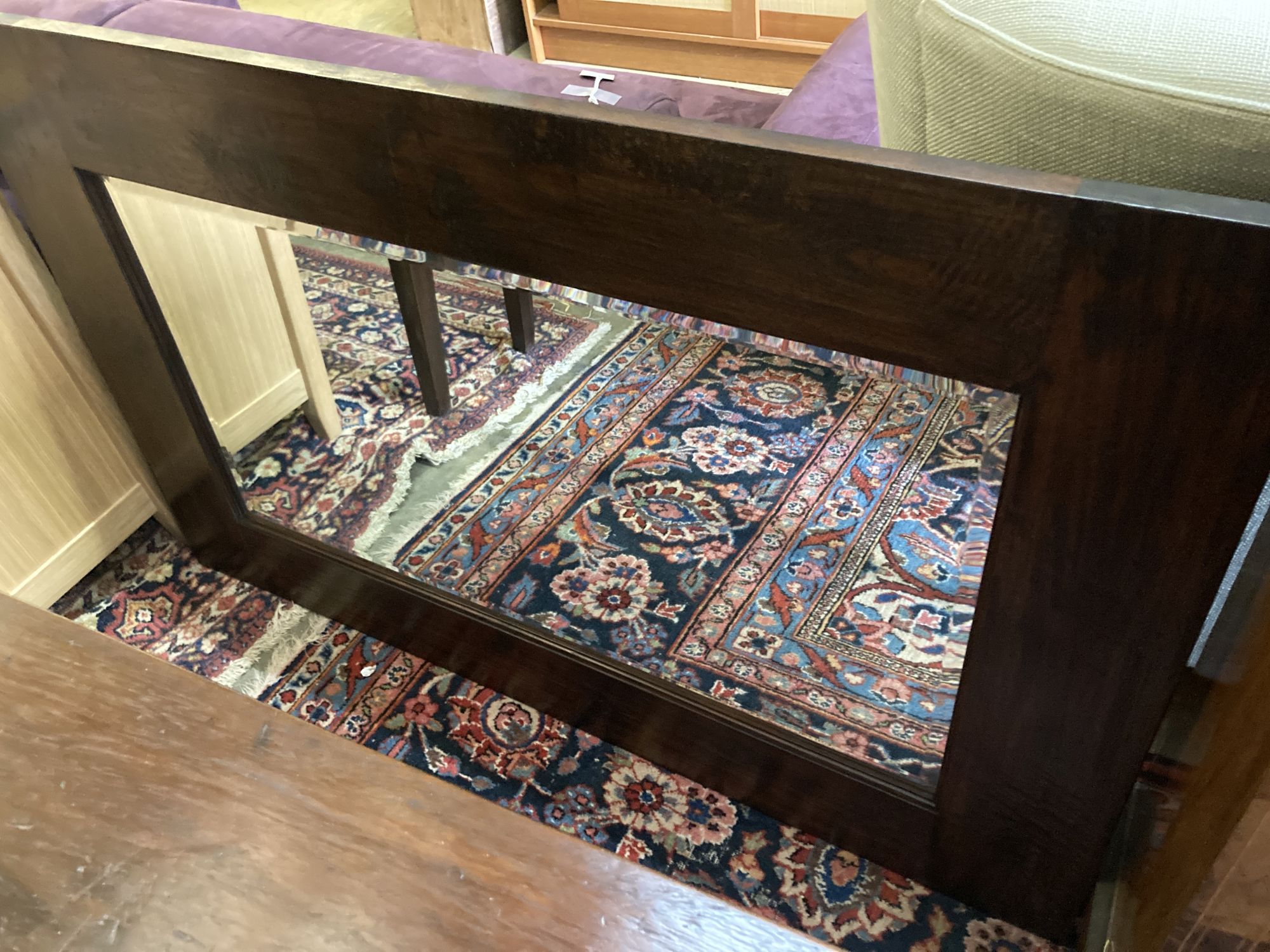 An Indian hardwood table, width 140cm, depth 40cm, height 76cm and a matching wall mirror